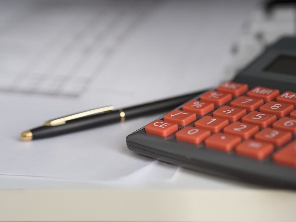 a calculator and a pen used by accountant